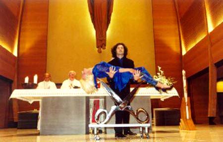 A magician performs a levitation act in front of a Church altar